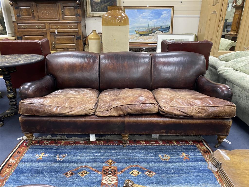 A George Smith Howard style brown leather three seater sofa, length 210cm, depth 106cm, height 84cm